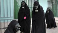 Unas mujeres vistiendo un "chador" llegan a un cementerio a preparar el cadáver de una persona fallecida por coronavirus, en Ghaemshahr, Irán.