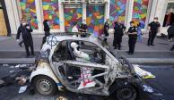 Policías observan un vehículo calcinado en el barrio de SoHo, Nueva York, el lunes 1 de junio de 2020, luego de una noche de protestas por la muerte de personas de raza negra a manos de la policía.