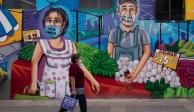 Una mujer pasa frente a un mural alusivo a trabajadores durante la pandemia, ayer, en Azcapotzalco.