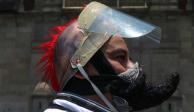 Un capitalino camina con una careta y un cubrebocas creativo para no contagiarse de COVID-19 en el Zócalo de la Ciudad de México