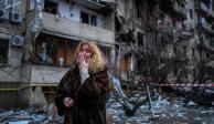 Una mujer llora frente a los escombros que dejó un ataque ruso en Kiev, Ucrania.