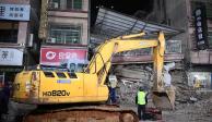 Los rescatistas trabajan junto a una excavadora en un sitio donde se derrumbó un edificio en Changsha, China.