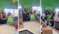 Varias mujeres intentan separar a una empleada y a una clienta que pelean en la zona de cajas de una tienda de autoservicio