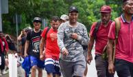 Migrantes sin tarjeta humanitaria caminan por la carretera rumbo hacia Estados Unidos.