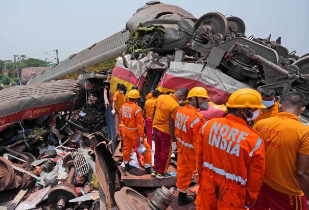 Con apoyo de maquinaria pesada recogen los escombros de los tres trenes impactados.