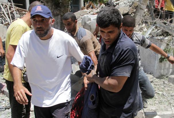 Residentes trasladan a una víctima herida tras otro bombardeo israelí en Gaza, ayer.