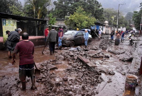 Pobladores de Huiloapan de Cuauhtémoc, Veracruz, retiran lodo y piedras de una calle, ayer.