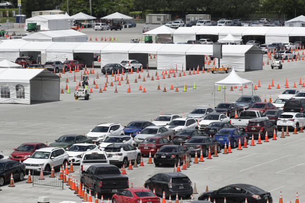Cientos de personas esperaron horas, formados en una kilométrica fila de autos, para hacerse la prueba de Covid-19, en Miami, Florida.