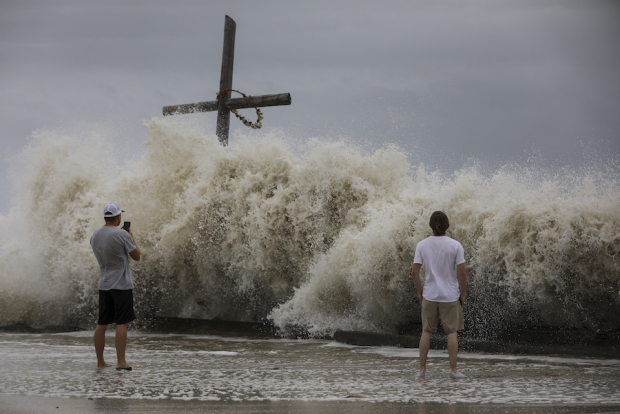 Residentes de Texas observan el impacto de una ola en High Island, ayer.