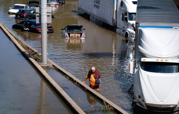 Una persona recorriendo las inundaciones de las calles del este de Estados Unidos