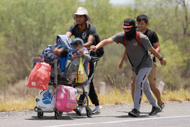 Migrantes caminan por la carretera Castaños-Monterrey rumbo a Piedras Negras, Coahuila, el pasado 22 de junio.