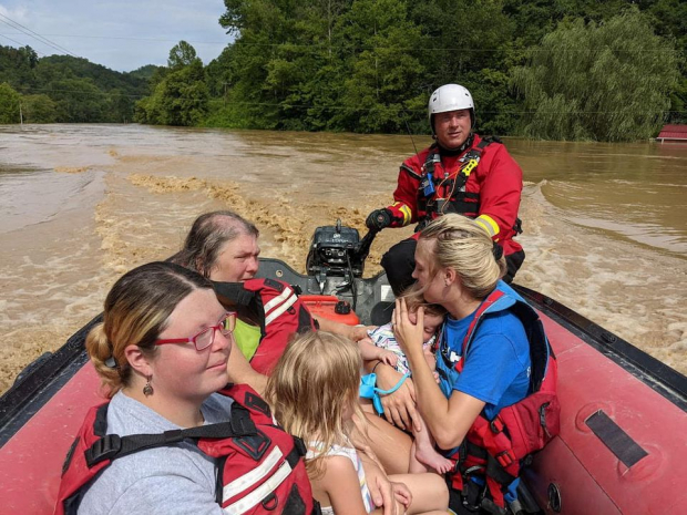 Un miembro del equipo de rescate evacua a los residentes de sus hogares en un bote a través de calles inundadas, en el condado de Breathitt, Kentucky.