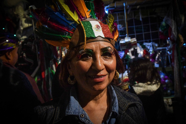 Una mujer luce su maquillaje en las inmediaciones del zócalo capitalino en donde se llevara a cabo la conmemoración del 213 aniversario de la Independencia de México