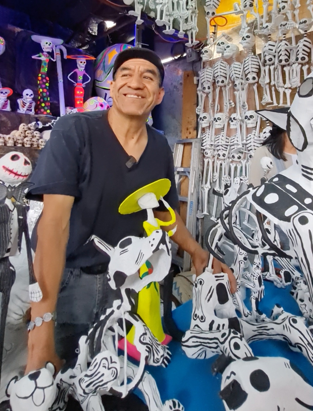 Jaime, un artesano, y su familia fabrican figuras de papel para el Día de Muertos.