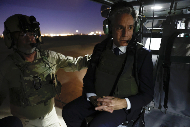El funcionario que porta chaleco antibalas aborda un helicóptero rumbo a Irak.