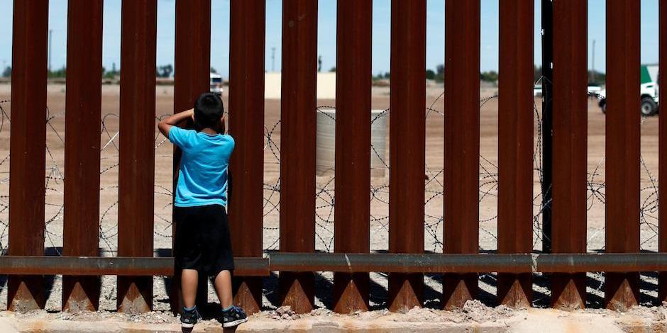 Un niño observa a través del muro fronterizo, en la frontera México-EU.