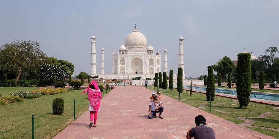 Un hombre toma una fotografía frente al histórico monumento de India.