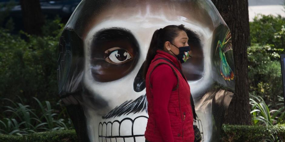 Mujer usa cubrebocas sobre Paseo de la Reforma