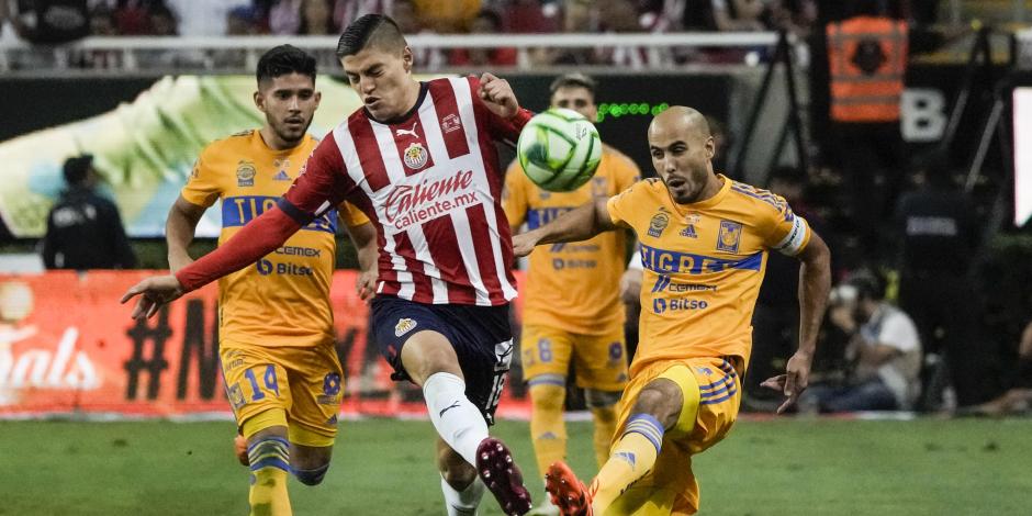 Ronaldo Cisneros y Guido Pizarro pelean por un balón en la final de vuelta de la Liga MX entre Chivas y Tigres.