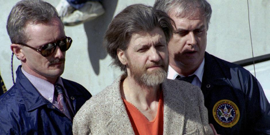 Theodore "Ted" Kaczynski es escoltado a su auto afuera de una corte federal en Helena, Montana, el 4 de abril de 1996