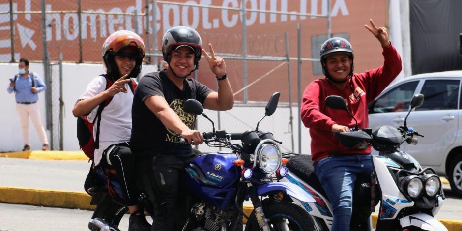 Tres jóvenes motociclistas detenidos en un crucero, piden que se les tome una fotografía