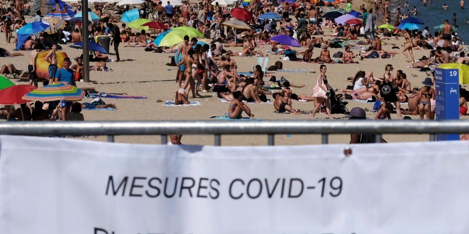 Levanta alerta y abre fronteras a turistas; las playas en Barcelona lucen abarrotadas (foto) sin que aún retiraran las  mantas de cerrado