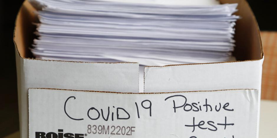 Una pila de documentos detallando los casos positivos de COVID-19, en una caja en las oficinas del Departamento de Salud Pública del condado Toledo-Lucas, en Ohio.