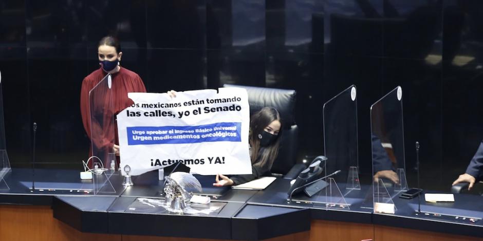La panista Martha Márquez muestra su letrero tras el enfrentamiento, ayer.