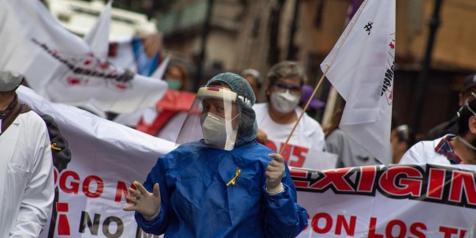 Vestidos con uniforme clínico, trabajadores de la salud protestan en el Zócalo, ayer.