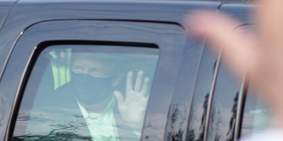 Donald Trump saluda a simpatizantes desde un vehículo, el 4 de octubre de 2020.