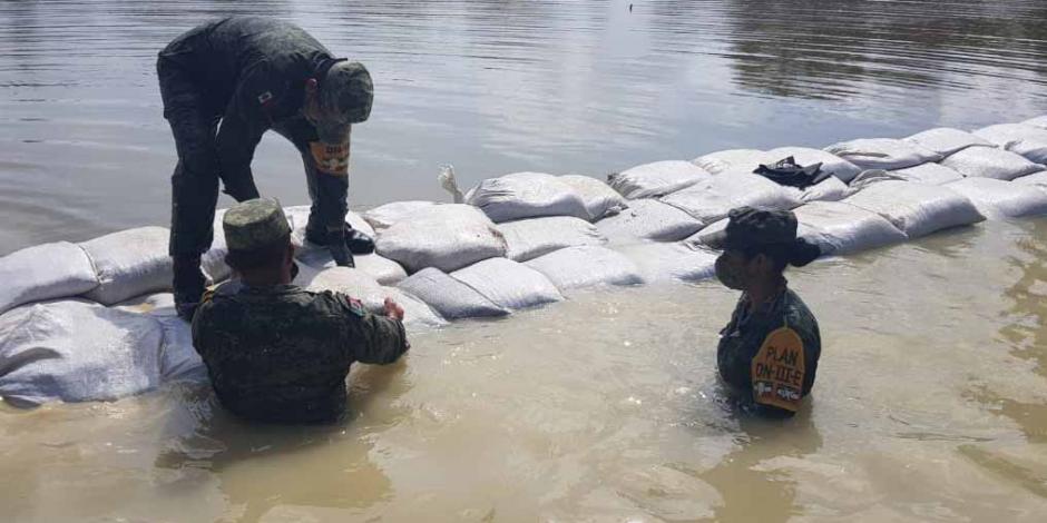 Elementos del Ejército refuerzan las costaleras para evitar el desborde de ríos en Tabasco.