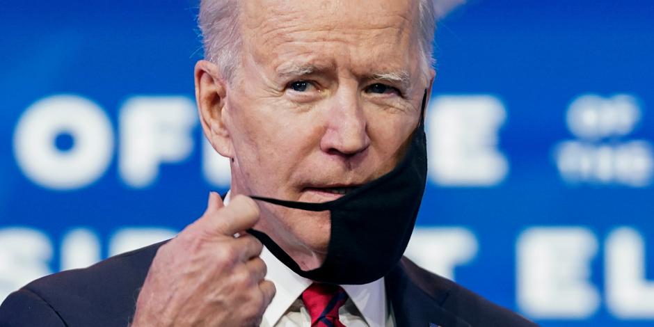 Joe Biden coloca su cubrebocas después de anunciar su plan para acelerar vacunación.