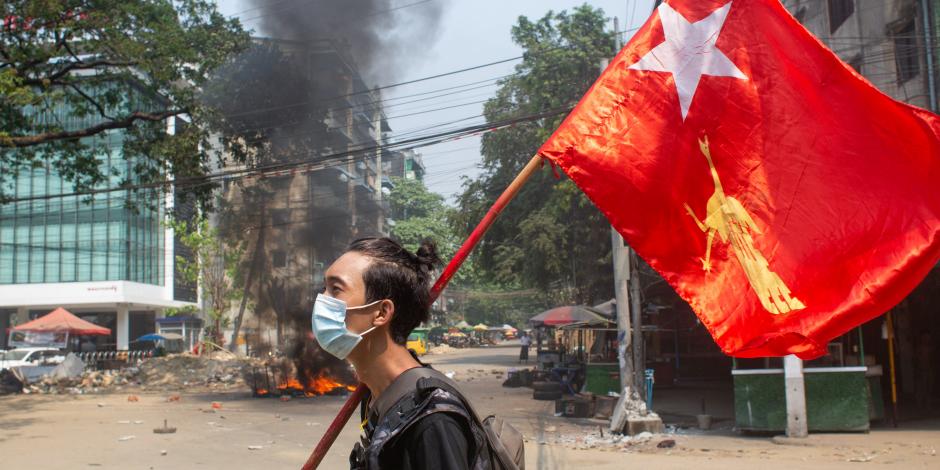 Un manifestante sostiene la bandera de la Liga Nacional de la Democracia, en rechazo al golpe de estado ocurrido en Myanmar.