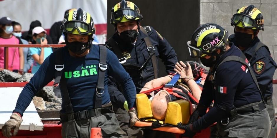 Elementos de cuerpos de emergencia simulan el rescate de una persona durante el Simulacro Nacional.