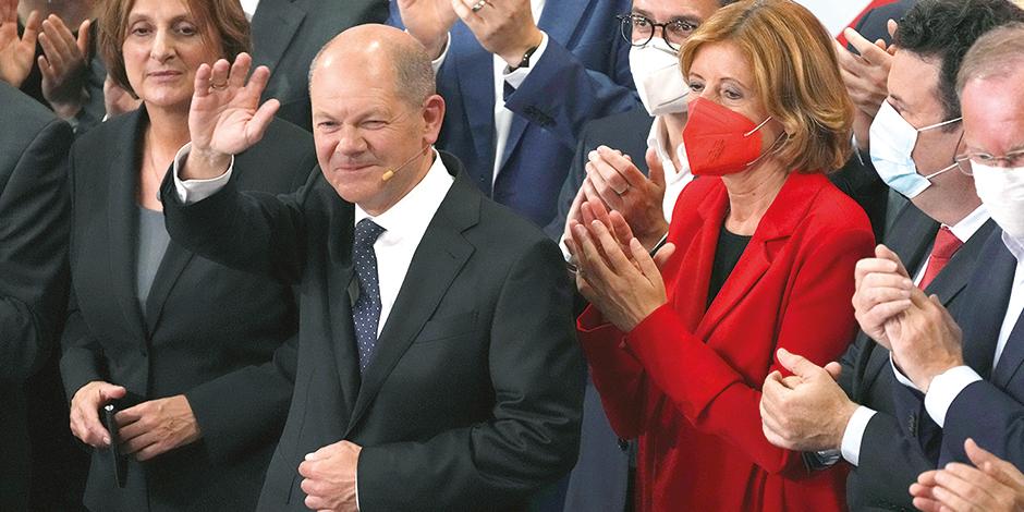 El virtual ganador socialdemócrata, Olaf Scholz (centro), celebra con las bases de su partido tras conocer los primeros sondeos, ayer.