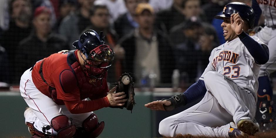 Michael Brantley, de los Astros de Houston, anota sobre el receptor de los Red Sox, Christian Vázquez, en el Juego 4 de la Serie de Campeonato de la Liga Americana.