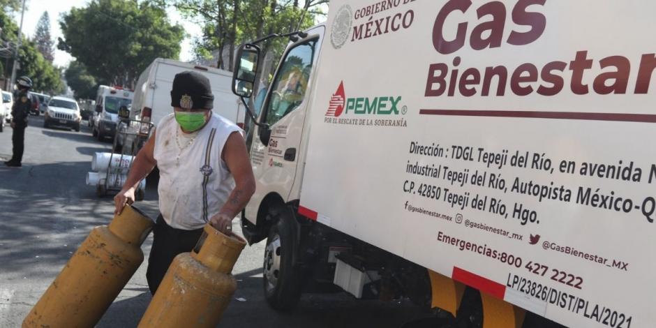 Un vecino toma dos tanques durante el arranque de Gas Bienestar en las alcaldías Iztacalco y Miguel Hidalgo.