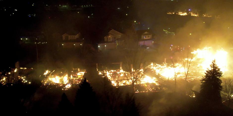 Fotografía aérea de un vecindario de Denver siendo consumido por el incendio forestal.