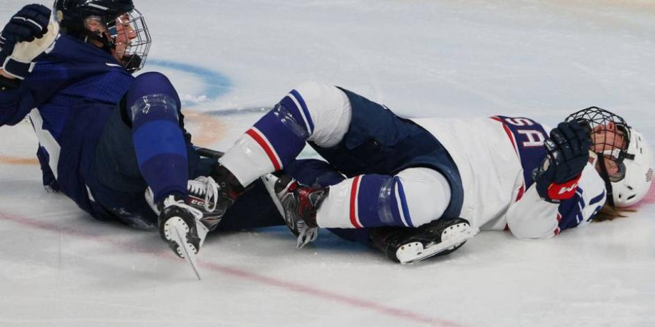 La jugadora de hockey Brianna Decker (derecha) después de su choque con una finlandesa en los Juegos Olímpicos de Invierno Beijing 2022.