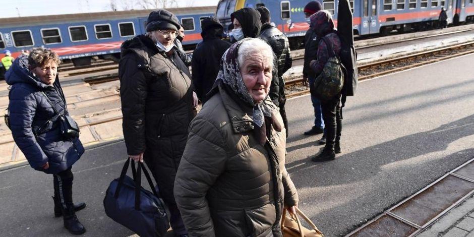 Ucranianos salen de un tren que transportaba a 275 personas para llegar a Zahony, Hungría, ciudad fronteriza con Ucrania.