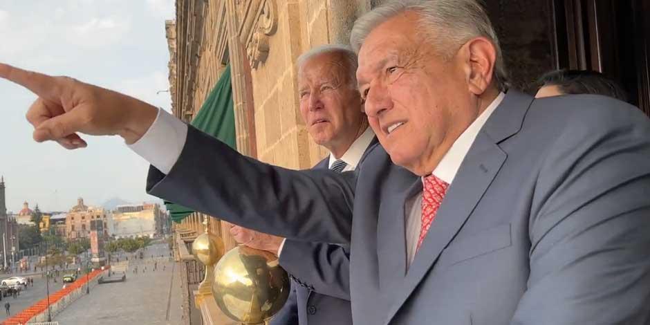 la imagen captura el momento en que AMLO muestra a Biden el Zócalo capitalino desde el balcón presidencial de Palacio Nacional