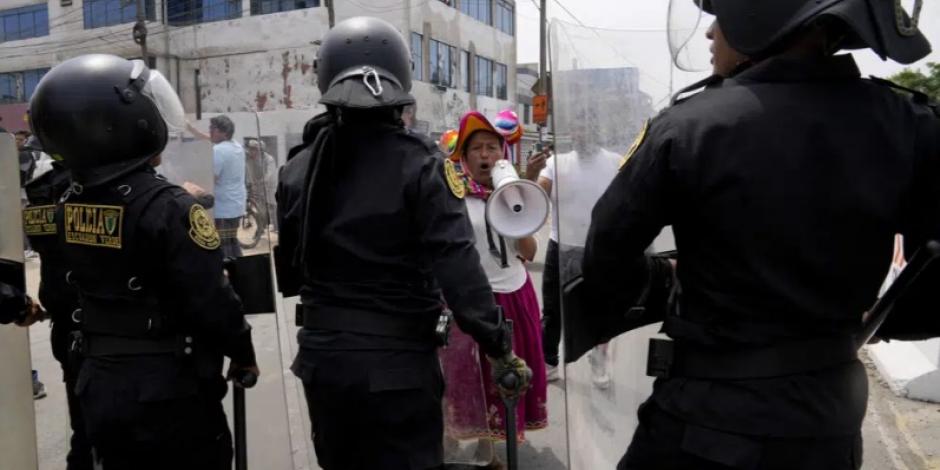 Un manifestante antigubernamental desafía a la policía que rodea la Universidad de San Marcos en Lima, Perú, el sábado 21 de enero de 2023.