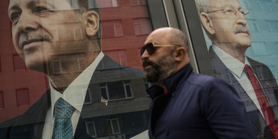 Un hombre pasa junto a carteles electorales del presidente de Turquía y candidato a la reelección de la Alianza Popular, Recep Tayyip Erdogan, a la izquierda, y el líder del partido CHP y candidato de la Alianza Nacional, Kemal Kilicdaroglu, en Estambul, el viernes 5 de mayo de 2023 en Estambul, Turquía.
