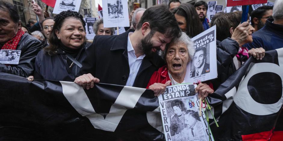 El presidente de Chile, Gabriel Boric (centro), participa en una manifestación con familiares de detenidos en la dictadura de Pinochet.