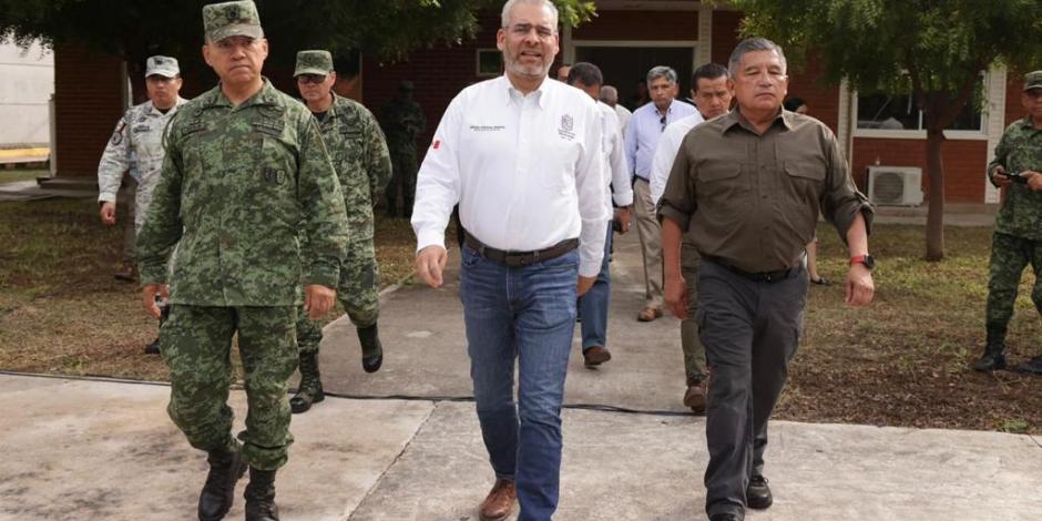 El gobernador de Michoacán, Alfredo Ramírez Bedolla y a su lado mandos de seguridad.