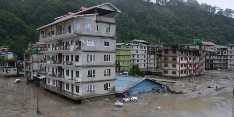 Un edificio de departamentos y una casa quedan sumergidos durante las repentinas inundaciones provocadas por lluvias monzónicas en el noroeste de India, donde 14 personas murieron hasta ahora, hay 102 desaparecidos y 22 mil damnificados.