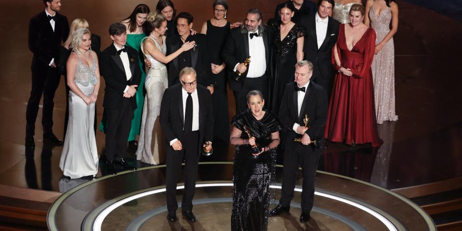 Emma Thomas  (centro) y Christopher Nolan (der.) reciben el premio a Mejor Película por Oppenheimer, ayer.