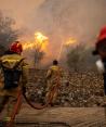 Bomberos intentan atajar un incendio forestal que arde en el pueblo de Hasia, cerca de Atenas, Grecia, el 22 de agosto de 2023.