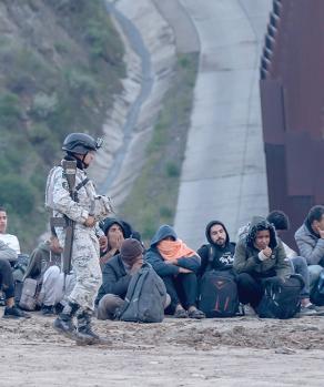 Migrantes detenidos junto al muro fronterizo en Tijuana, el pasado 1 de abril.